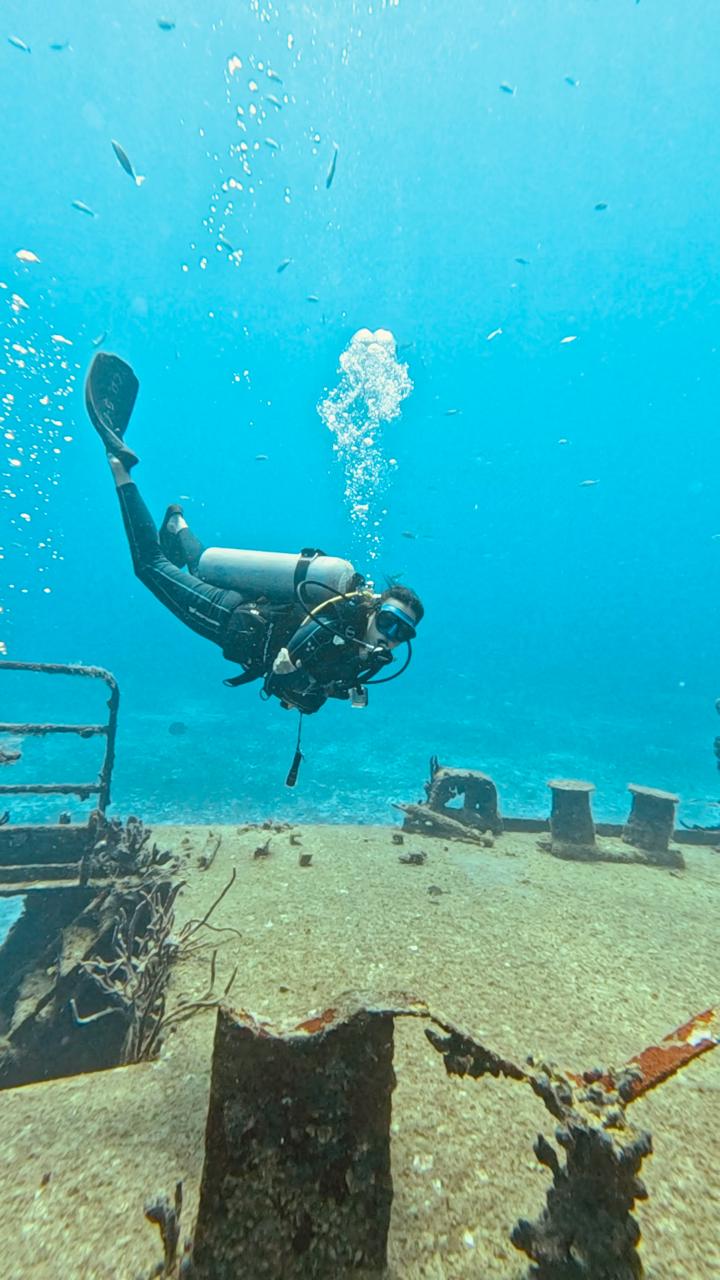 Diver over wreck deck in Cozumel